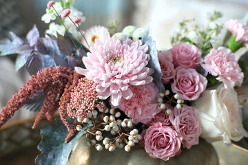Bouquet of autumn flowers collected in a pumpkin