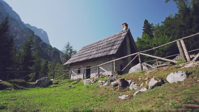 Old Alpine stone cottage with wooden roof
