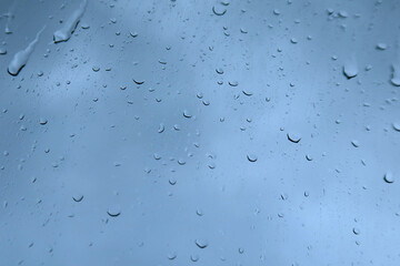 Rain on the window, glass. Raindrops, close-up. Selective focus. Bad weather, autumn rain. Liquid water drops on glass surface