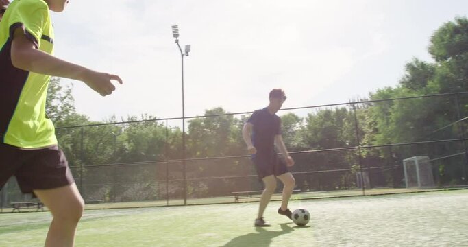 Father and daughter playing football on soccer field,4K