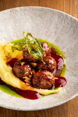 beef meatballs with mashed potato and cranberry sauce
