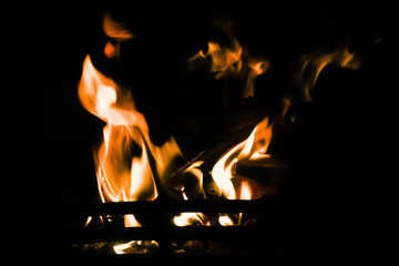 Fire on a black background, firewood, wood burn in a fireplace