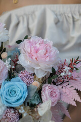 Preserved roses with dried flowers bouquet closeup. Eternal, stabilized rose flower in turquoise colors. Beautiful flowers.