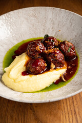 beef meatballs with mashed potato and cranberry sauce
