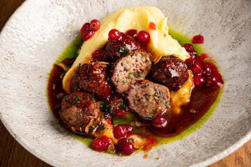 beef meatballs with mashed potato and cranberry sauce