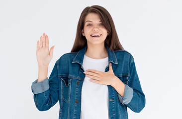 Beautiful young woman over isolated background Swearing with hand on chest and open palm, making a...