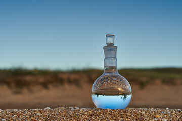 Glass flask by the sea.