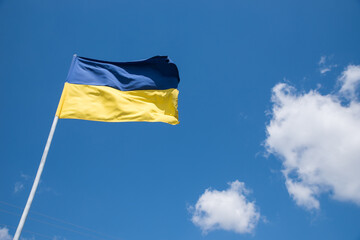 Ukrainian blue and yellow flag on the sky background