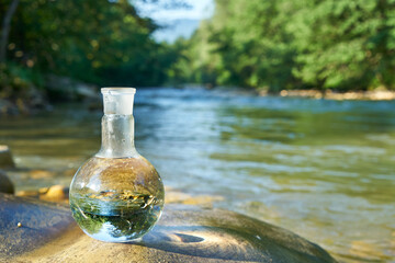 Flask with clear river water.