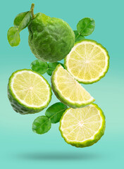 Fresh Bergamot fruit with leaves isolated on green background, Bergamot fruit with slice on green background With clipping path.