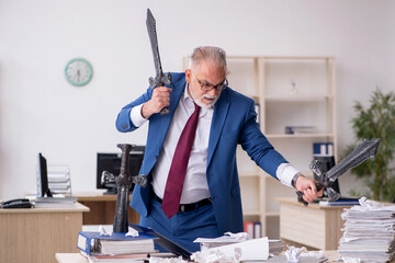 Old male employee unhappy with excessive work in the office