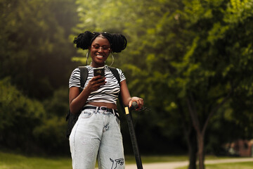 Beautiful African American woman,riding her electric scooter and using a mobile phone © Shopping King Louie