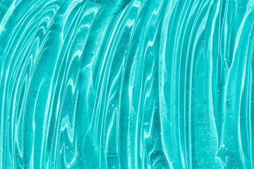 Clear transparent skincare product sample closeup. Blue gel texture. Hand sanitizer, alcohol gel,...