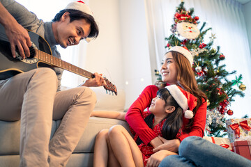Asian lovely family member enjoy sing Christmas song together at home. 