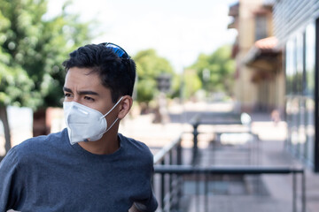 Hispanic teen boy wearing protective mask in the new normal.