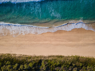 Aerial photo of a beach and trees in Ulladulla, NSW, Australia
