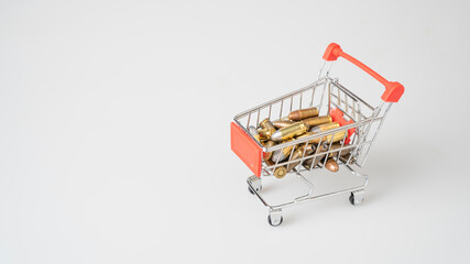 Close-up shot of a 9mm ammunition in a shopping cart, on a white background.