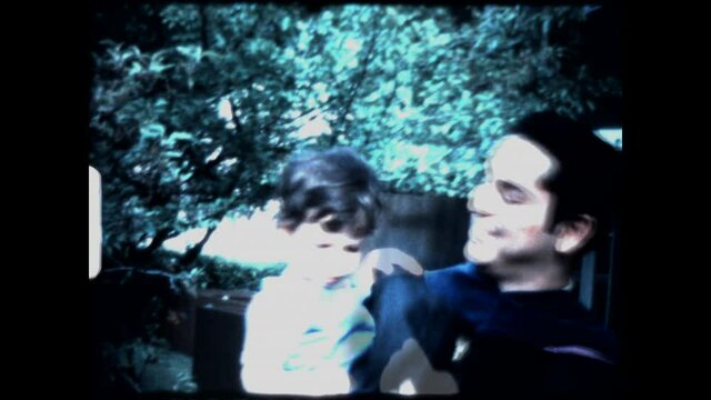 Dad Celebrates Graduation 1974 - A father celebrates his graduation with his young son. 