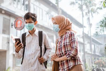 Asian woman and man with medical disposable mask to avoid viruses