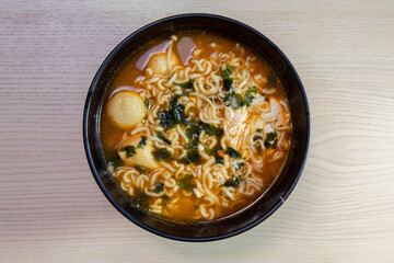 A bowl of hot and spicy noodle soup.