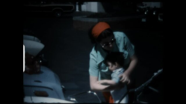 Mother Kisses Child 1974 - Mother picks up and kisses her child. 