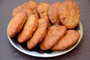closeup the bunch red brown color frayed bread in the steel plate over out of focus grey brown background.