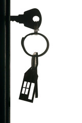Silhouette of the keys with keyring in the door keyhole isolated on white background