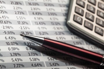 Calculator, Pen and Financial Figures
