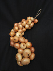 Onions knitted in a pigtail. Storage for winter.
