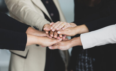 Close up shot of holding hands of unidentified unrecognizable successful female businesswoman group...