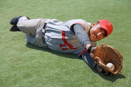 Baseball Player Diving To Catch The Ball