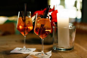 Aperol Spritz Cocktail. Alcoholic beverage based on table with ice cubes and oranges.