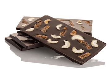 Dark raw chocolate with cashews and dried figі on a white background.