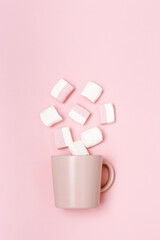 Romance holiday concept, pink mug or cup and marshmallows