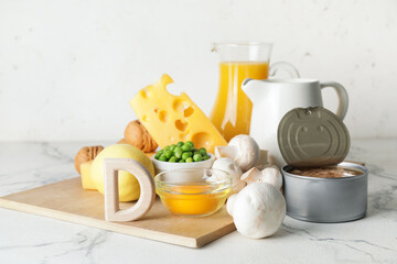 Letter D and different healthy products on light background