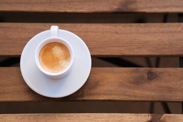 Cup of coffee on wooden table