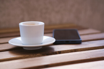Cup of coffee on wooden table
