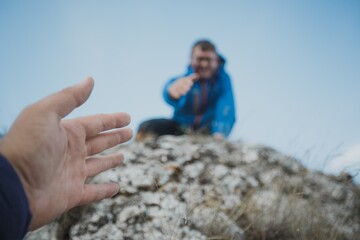 Couple rock climbing together in mount
