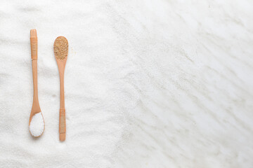 Fototapeta na wymiar Spoons with sugar on light background