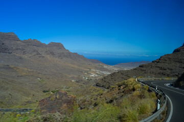 Fototapeta na wymiar Rocks in the north of the Gran Canaria island. The road passes over the cliffs, the ocean is visible