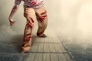 Scary zombie with blood and wound on his body walking