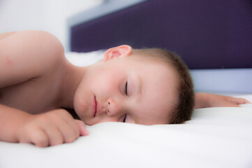 child sleeping on white