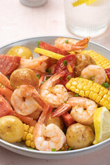 Shrimp boil heap with corn, baby potatoes, sausage and lemons.