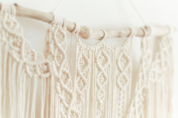 Beautiful boho macrame on wall panel. tapestry in the style of Boho made of cotton threads in natural color using the macrame technique for home decor and wedding decoration. light pastel colors