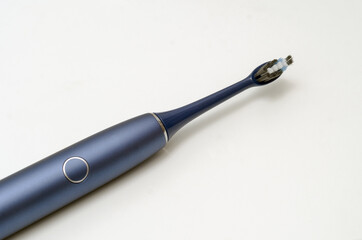 electric sonic toothbrush in blue on a white background. Cleanliness and hygiene of the oral cavity.