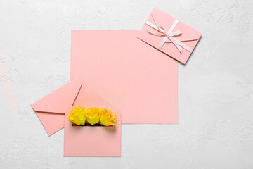 Blank card and envelopes with roses on white background