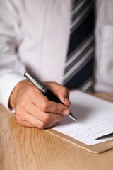 Businessman Taking Notes on a Clipboard
