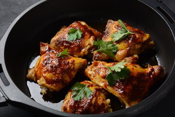 Roasted chicken leg quarters seasoned with garlic and herbs in a baking dish