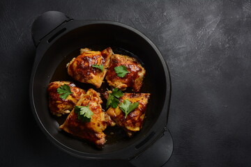 Roasted chicken leg quarters seasoned with garlic and herbs in a baking dish