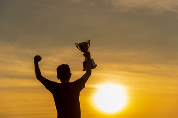 Winner win hands holding golden champion trophy cup prize. Silhouette best award victory hands...